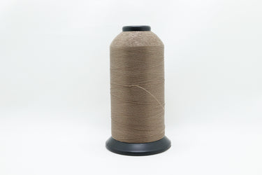 Cone of lubricated polyester thread made from pre-stabilised high tenacity continuous filament polyester in sand beige