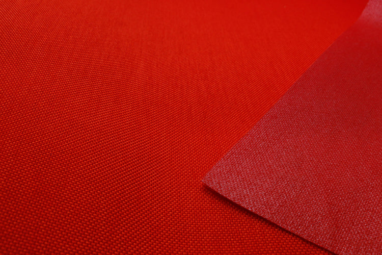 Close-up of orange colored Cordura Classic 1000D nylon 6.6 fabric texture