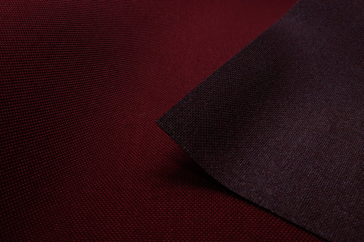 Close-up of wine colored Cordura Classic 1000D nylon 6.6 fabric texture