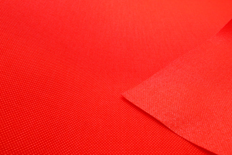 Close-up of fluorescent orange colored Cordura Classic 1000D nylon 6.6 fabric texture
