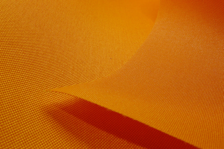 Close-up of mango colored Cordura Classic 1000D nylon 6.6 fabric texture