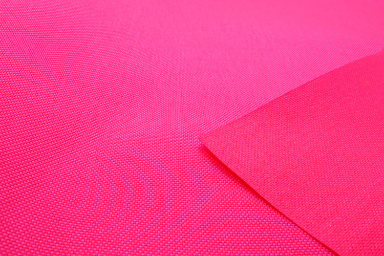 Close-up of neon pink colored Cordura Classic 1000D nylon 6.6 fabric texture