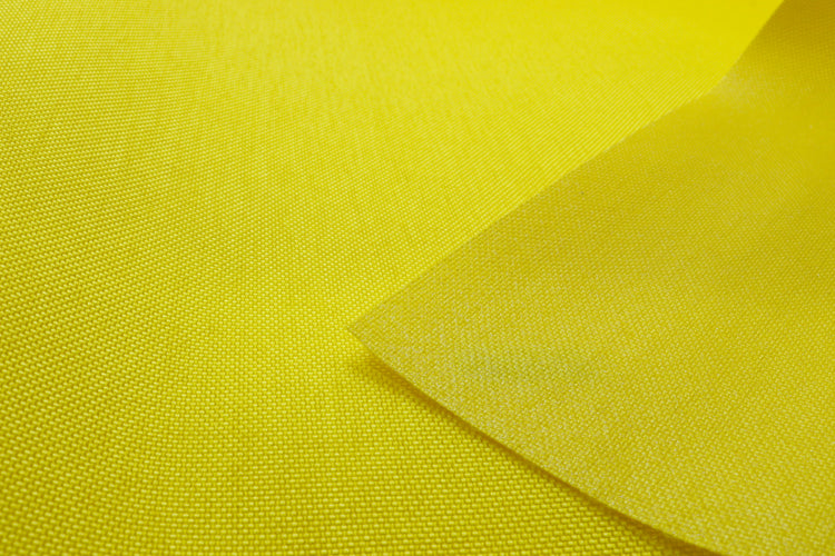 Close-up of yellow colored Cordura Classic 1000D nylon 6.6 fabric texture