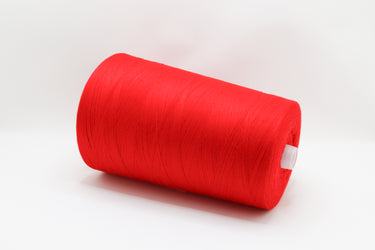 A large spool of bright red thread or yarn, shown at an angle on a clean white background.