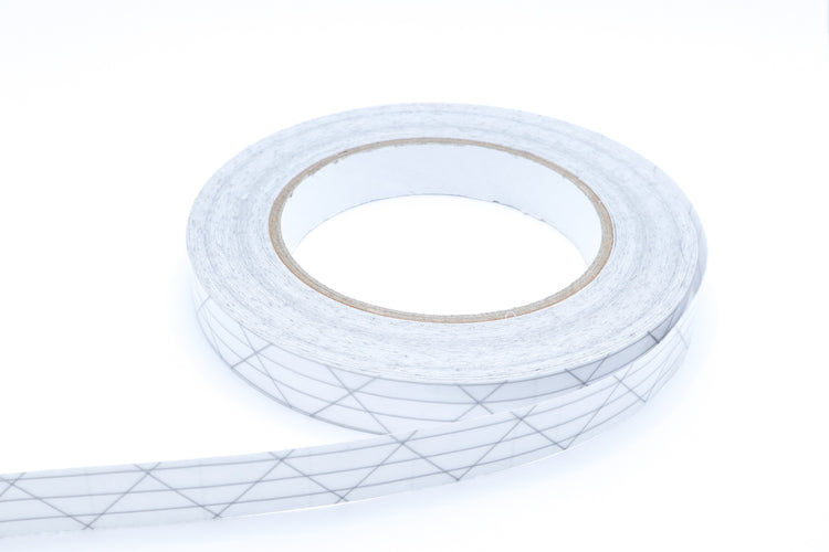 Close-up of UltraTNT™ PSA Tape showing the pressure-sensitive adhesive layer for sealing seams on technical fabrics.