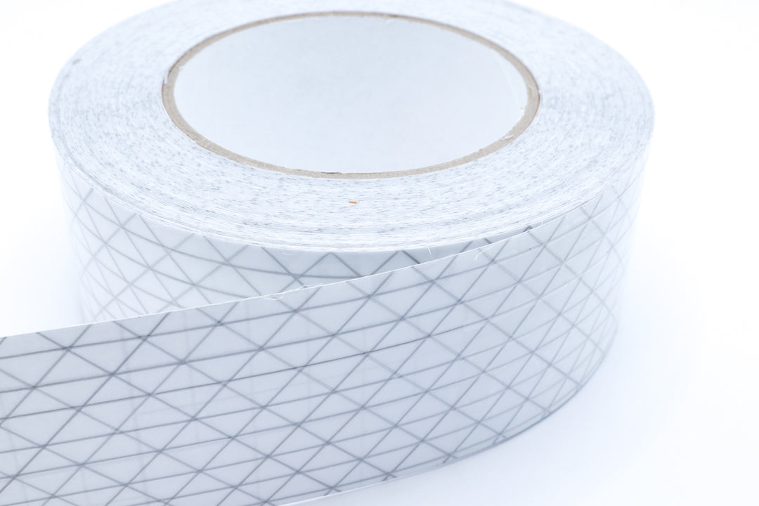 Close-up of UltraTNT™ PSA Tape showing the pressure-sensitive adhesive layer for sealing seams on technical fabrics.