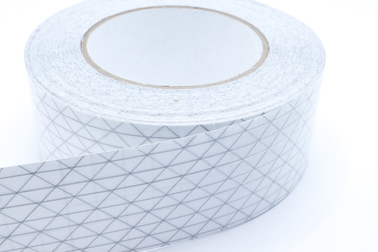 Close-up of UltraTNT™ PSA Tape showing the pressure-sensitive adhesive layer for sealing seams on technical fabrics.
