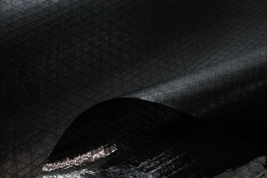 A close up of UltraTenX uhmwpe waterproof fabric with grid/ripstop in black