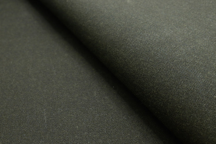 Close-up of waxed cotton canvas finish, highlighting the wax coating that repels water.