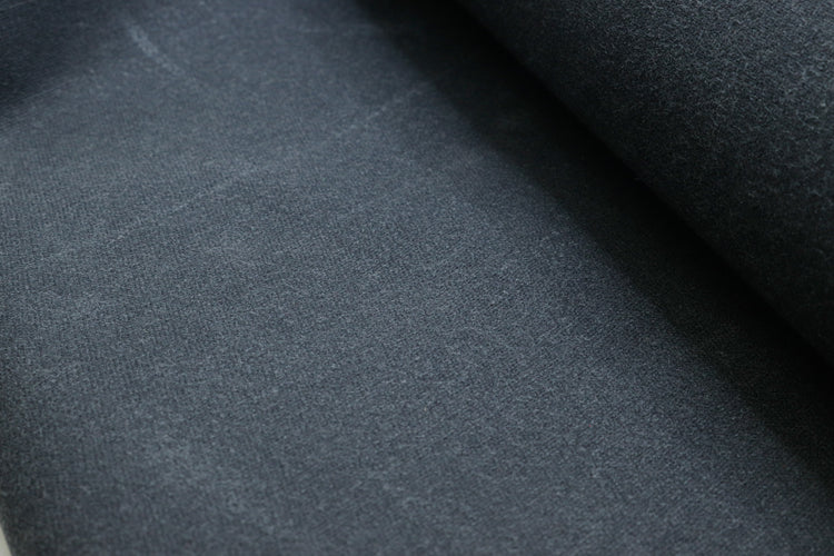Close-up of waxed army duck canvas showing the dense weave and waxed coating for durability and water resistance.