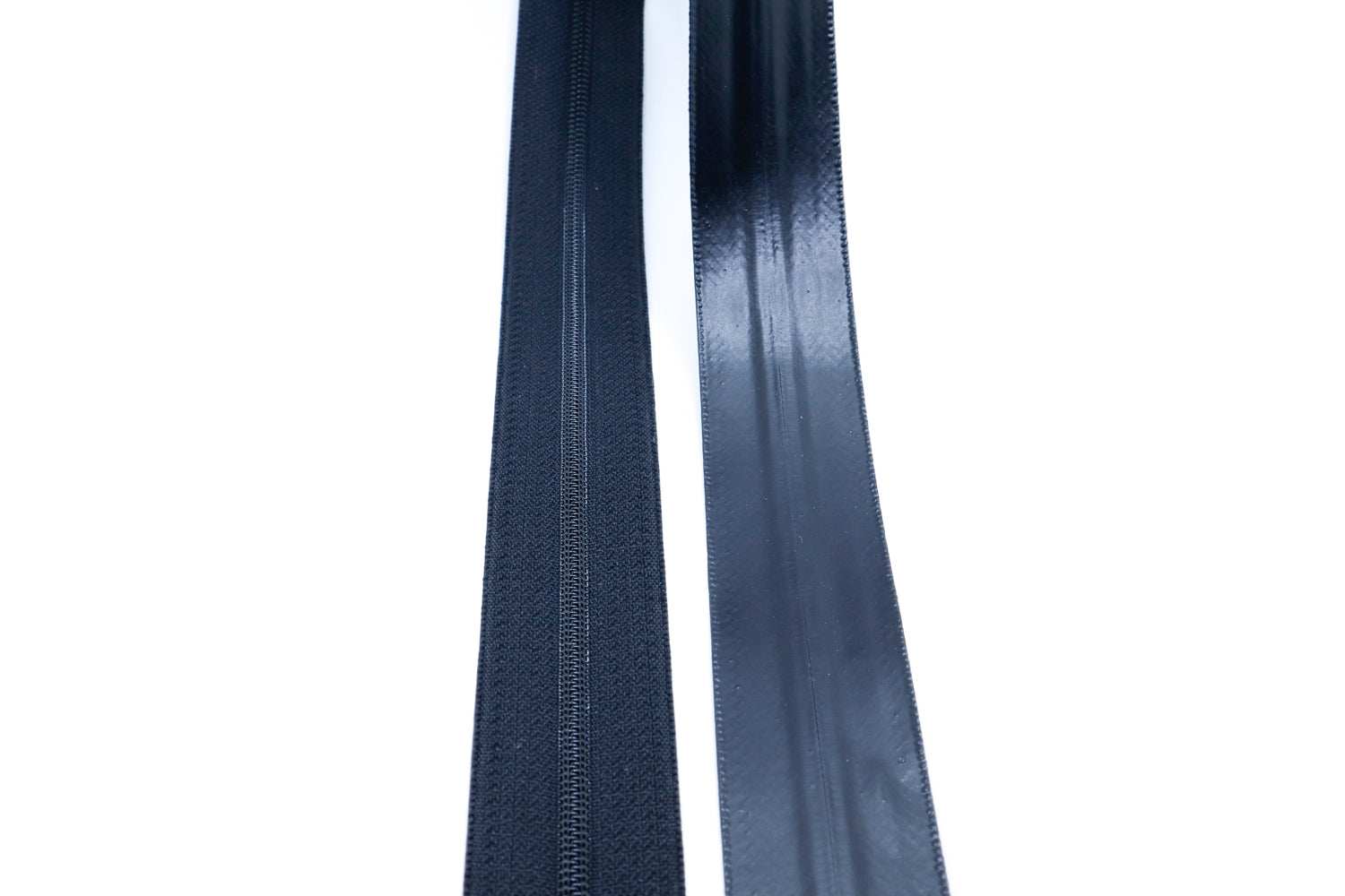 Close-up of YKK AquaGuard NATULON® zipper tape and PU-coated surface for water resistance and durability.