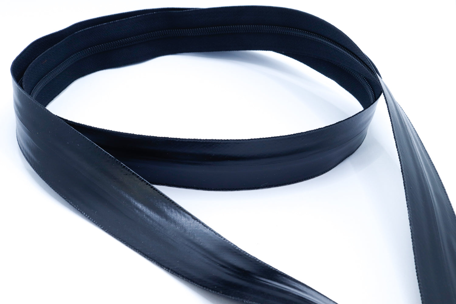 Close-up of YKK AquaGuard NATULON® zipper tape and PU-coated surface for water resistance and durability.