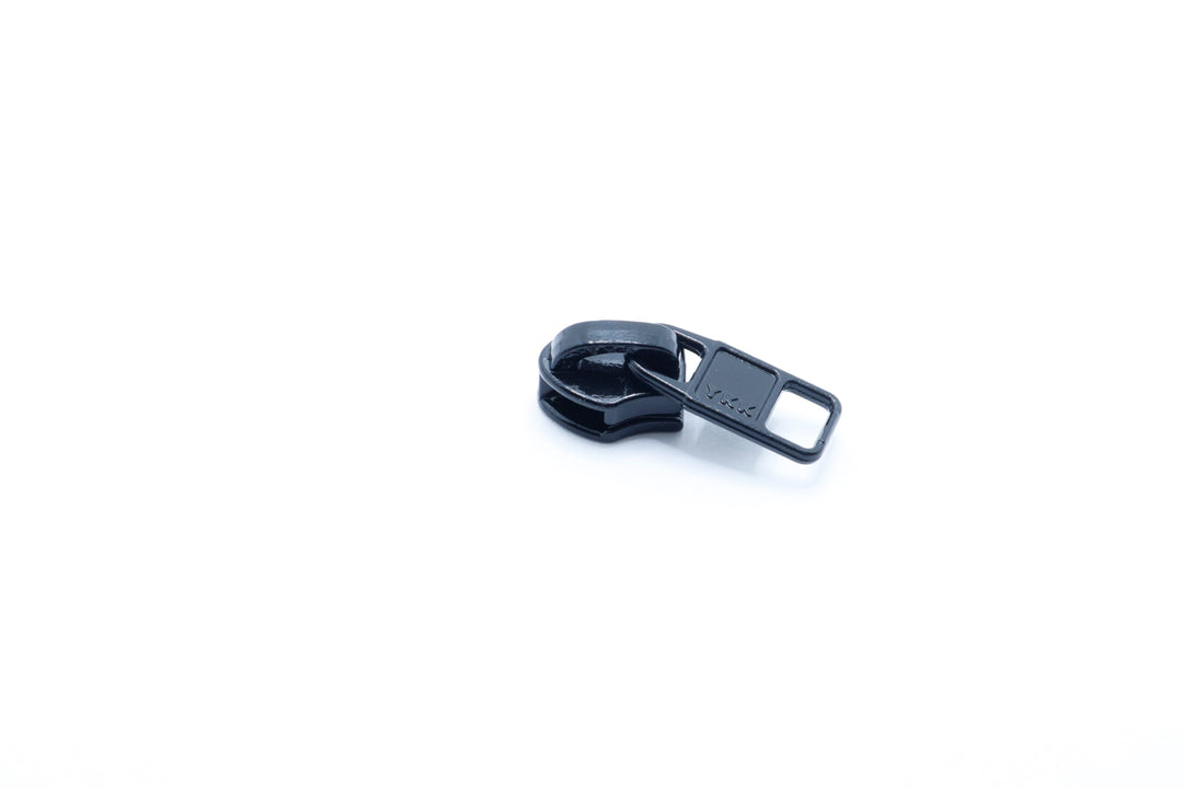 YKK zipper slider with a square tab and enamel coating