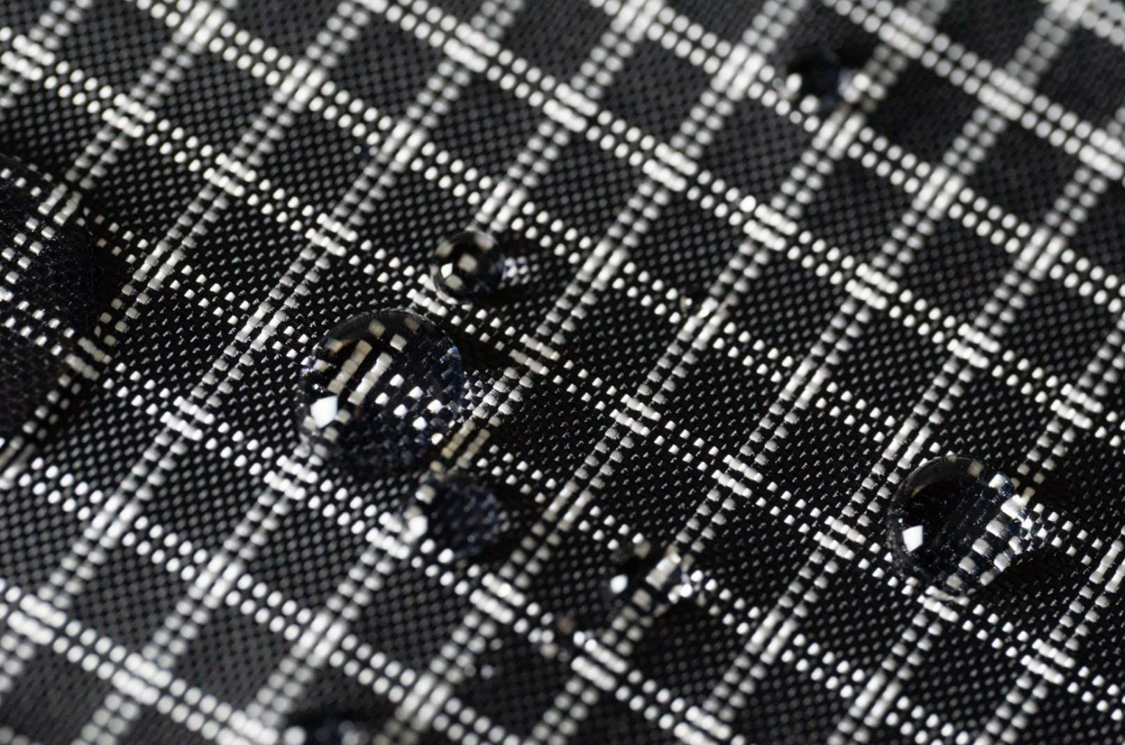 Black ultragrid fabric with UHMWPE gridstop. Water-resistant fabric