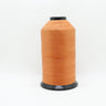 lubricated polyester thread made from pre-stabilised high tenacity continuous filament polyester in burnt orange shown up close