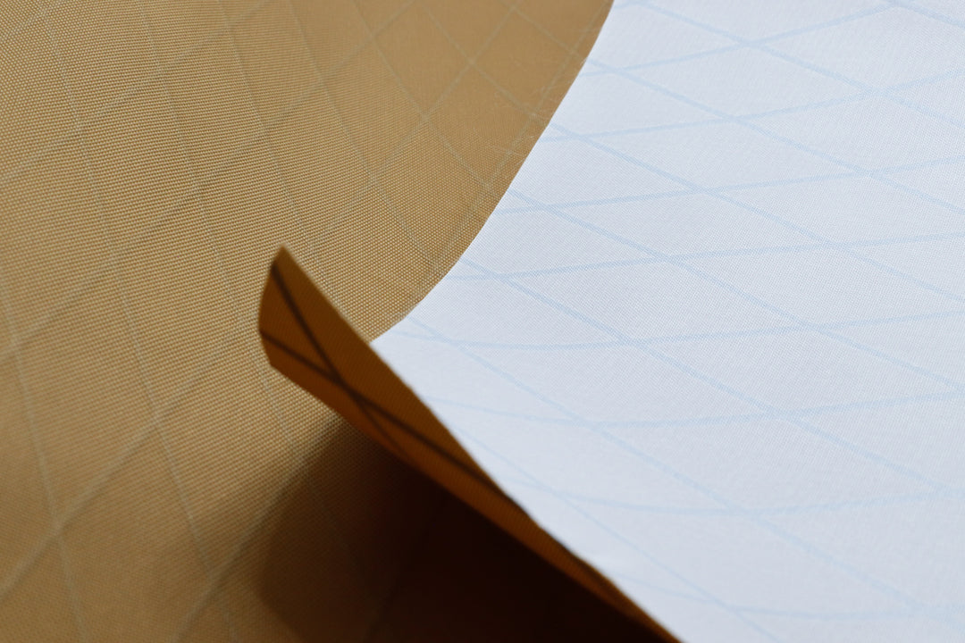Close up of X-PAC VX21 ripstop fabric in coyote brown to show texture and x-ply ripstop grid of the fabric