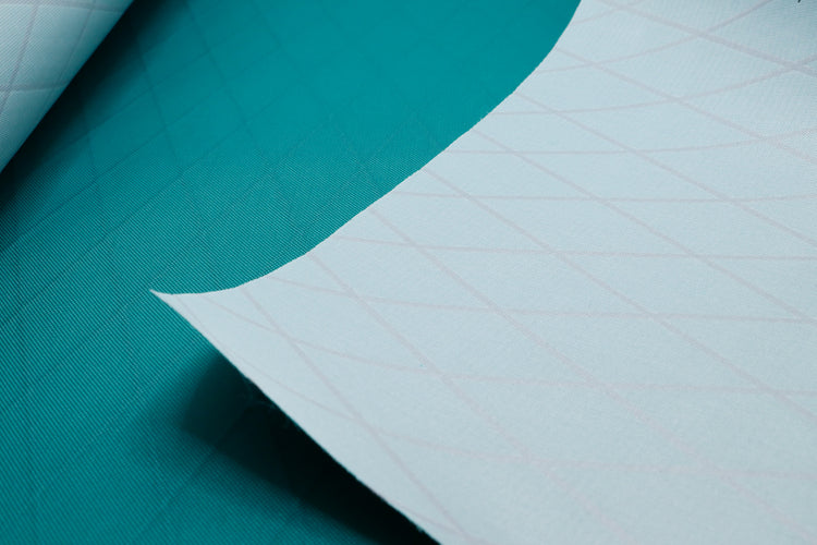 Close up of X-PAC VX21 fabric in cadmium green to show the x-ply ripstop grid and texture of the fabric weave