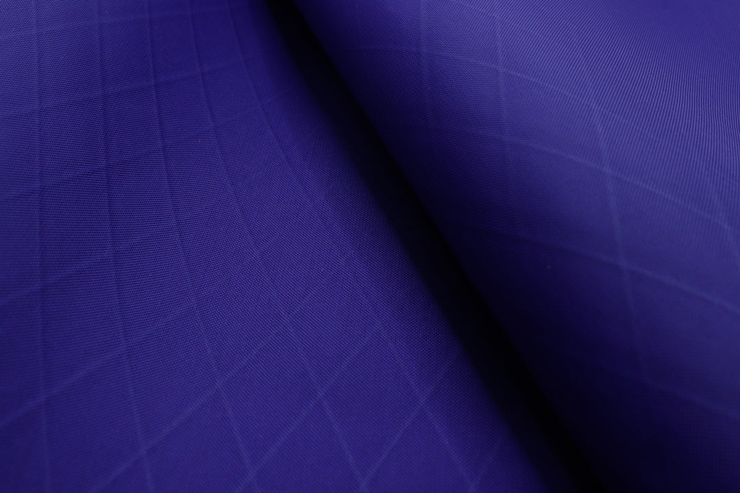 X-PAC VX21 fabric in purple close up showing the x-ply ripstop pattern of the fabric. 