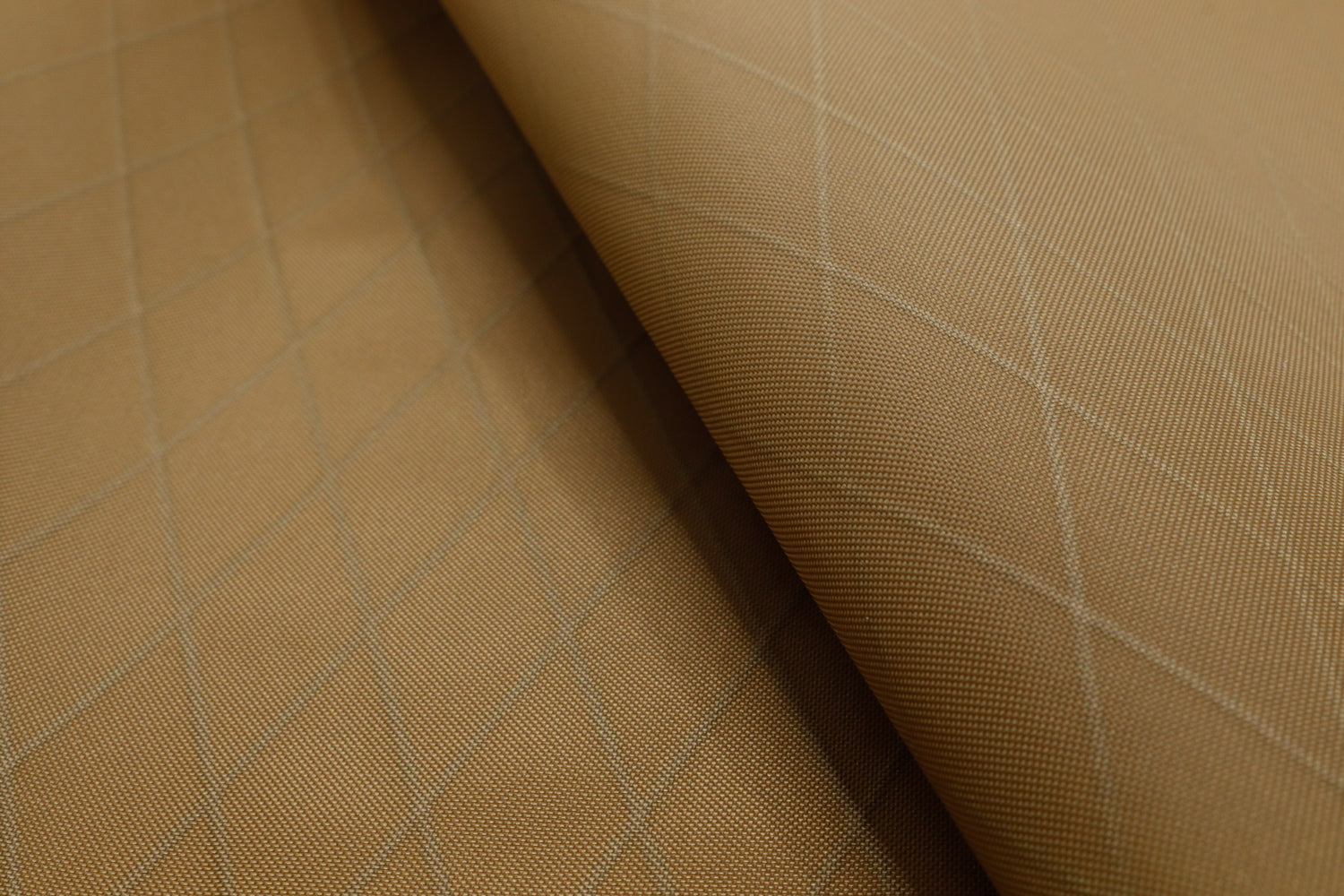 Close up of X-PAC VX21 ripstop nylon fabric in coyote brown showing the x-ply ripstop pattern of the fabric
