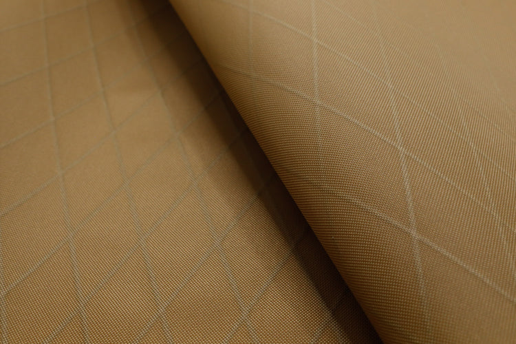 Close up of X-PAC VX21 ripstop nylon fabric in coyote brown showing the x-ply ripstop pattern of the fabric