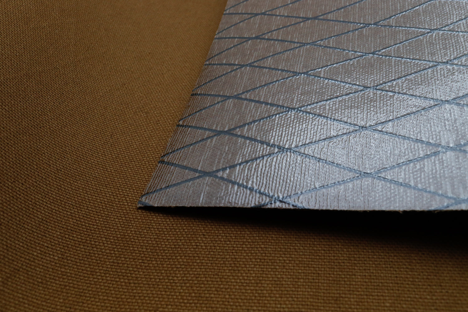Close up of X-PAC X11 cotton duck pack fabric showing the texture and ripstop x-ply grid in mountain brown