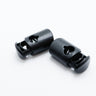 Black plastic cord locks on a white background