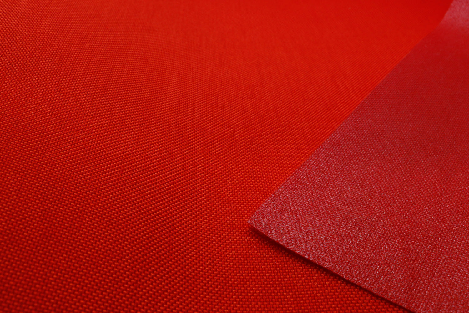 Close-up of orange colored Cordura Classic 1000D nylon 6.6 fabric texture
