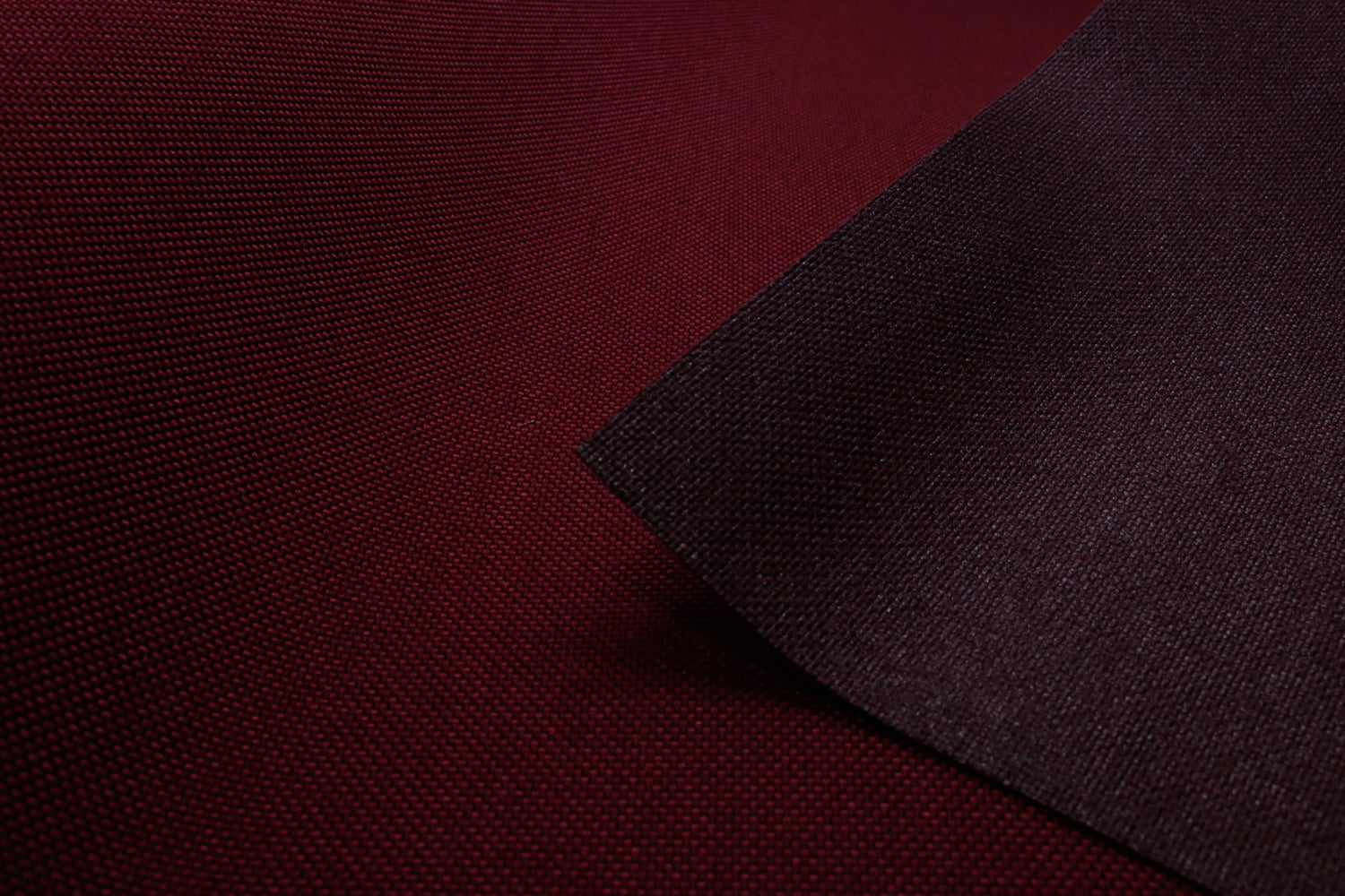 Close-up of wine colored Cordura Classic 1000D nylon 6.6 fabric texture