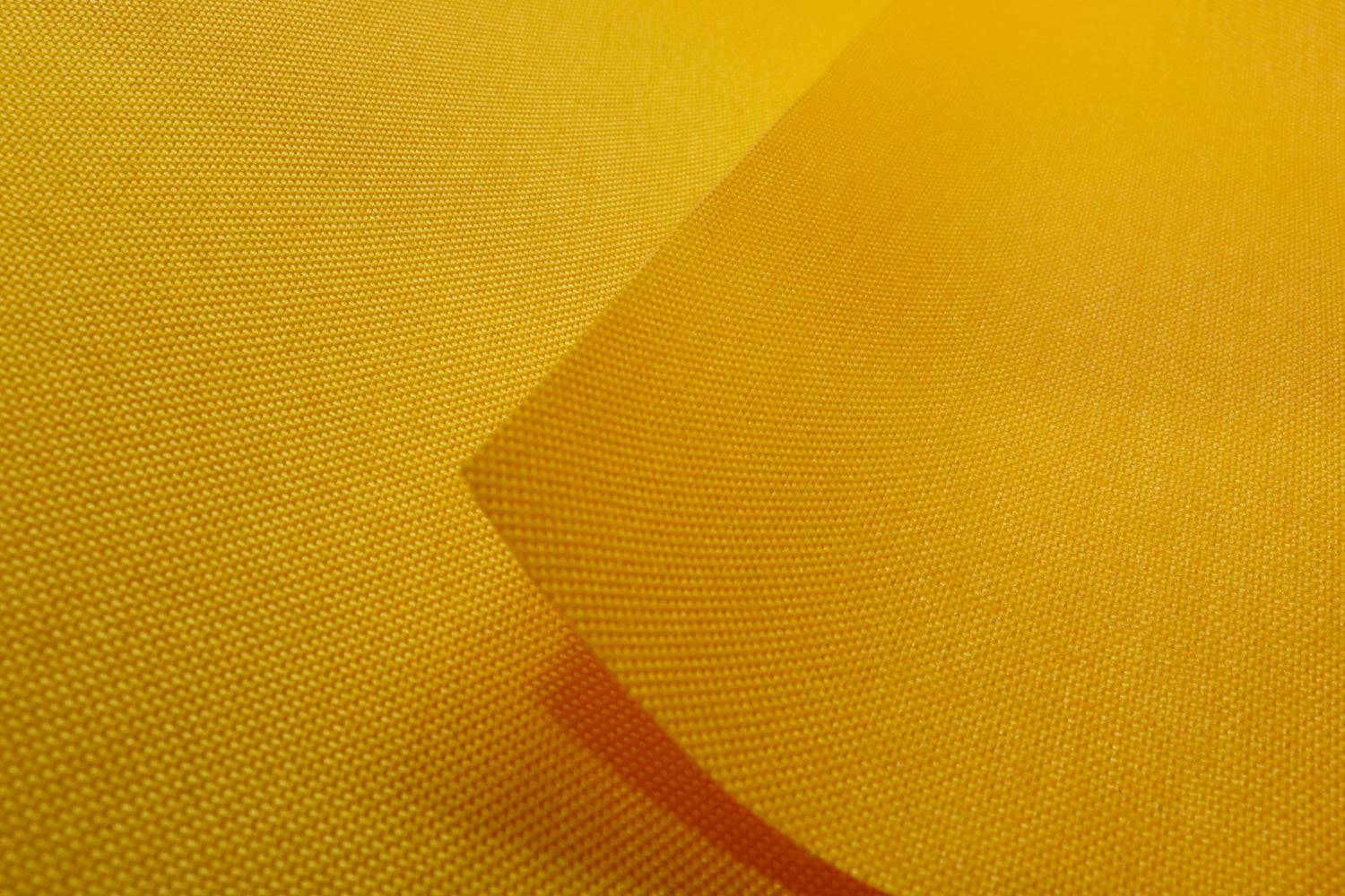 Close-up of gold colored Cordura Classic 1000D nylon 6.6 fabric texture
