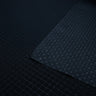 close-up of front and back of black diamond ripstop nylon fabric