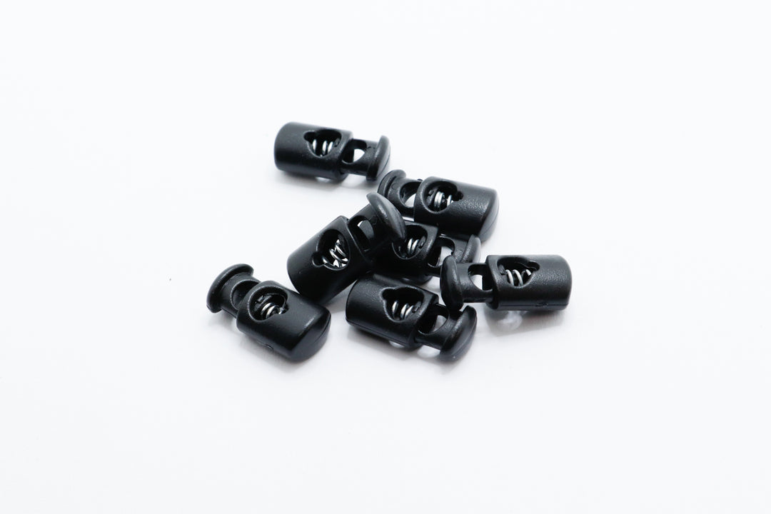 black plastic cord locks on a white background
