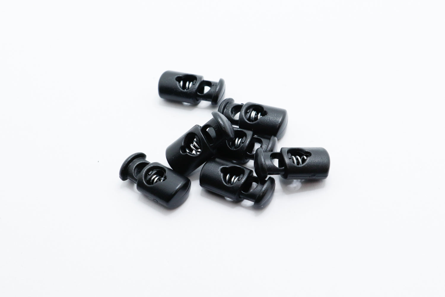 black plastic cord locks on a white background