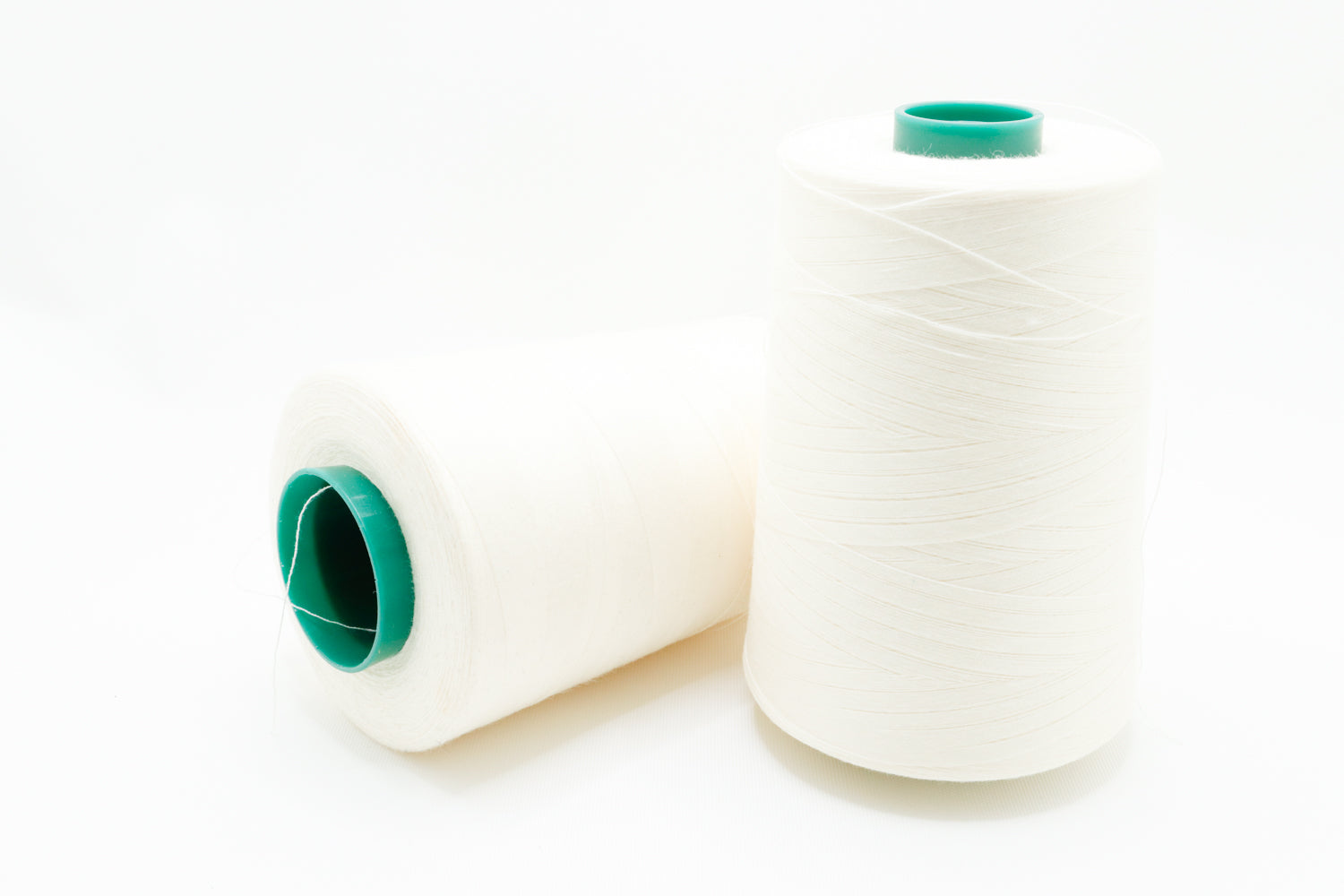 two 6000 yard spools of thread used for sewing.