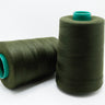 Two spools of green thread with teal ends on a white background