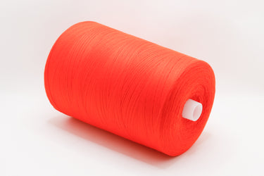 A large spool of bright orange-red thread or yarn, shown lying on its side on a clean white background.
