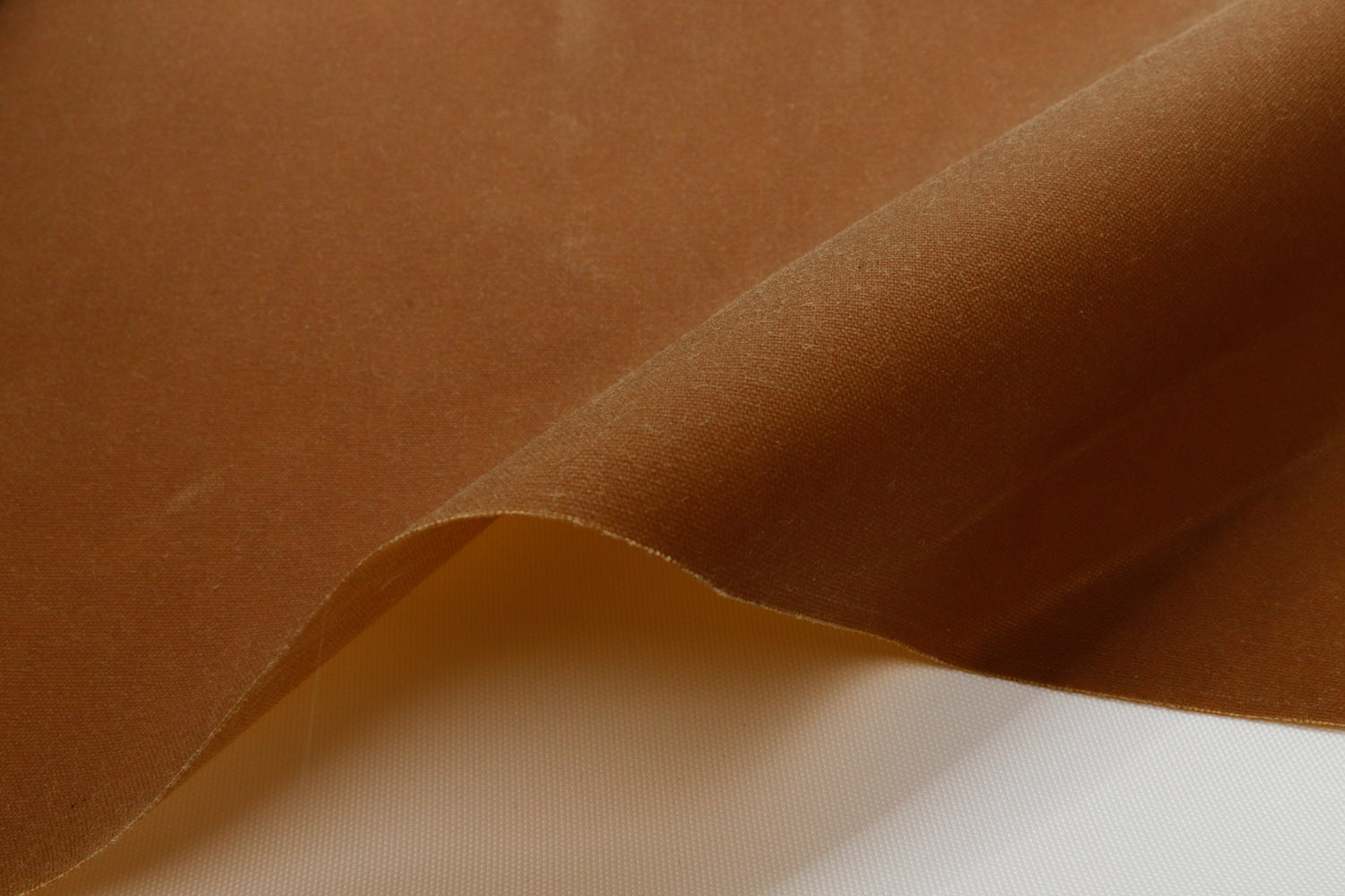 close up of a tan waxed canvas showing the texture
