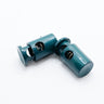 two green plastic cord lock on a white background