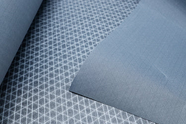 Close up of Ultra80tx ripstop fabric showing the front and back. Highlighting the UHMWPE ripstop grid on the fabric