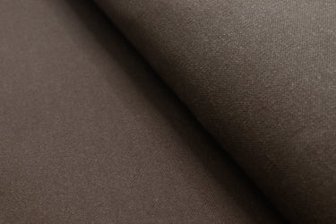 Close-up of waxed canvas showing natural creases and texture, perfect for handcrafted gear with character.