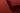 A close-up of a deep red or burgundy fabric, shown with one corner folded over to reveal the material texture and edge.