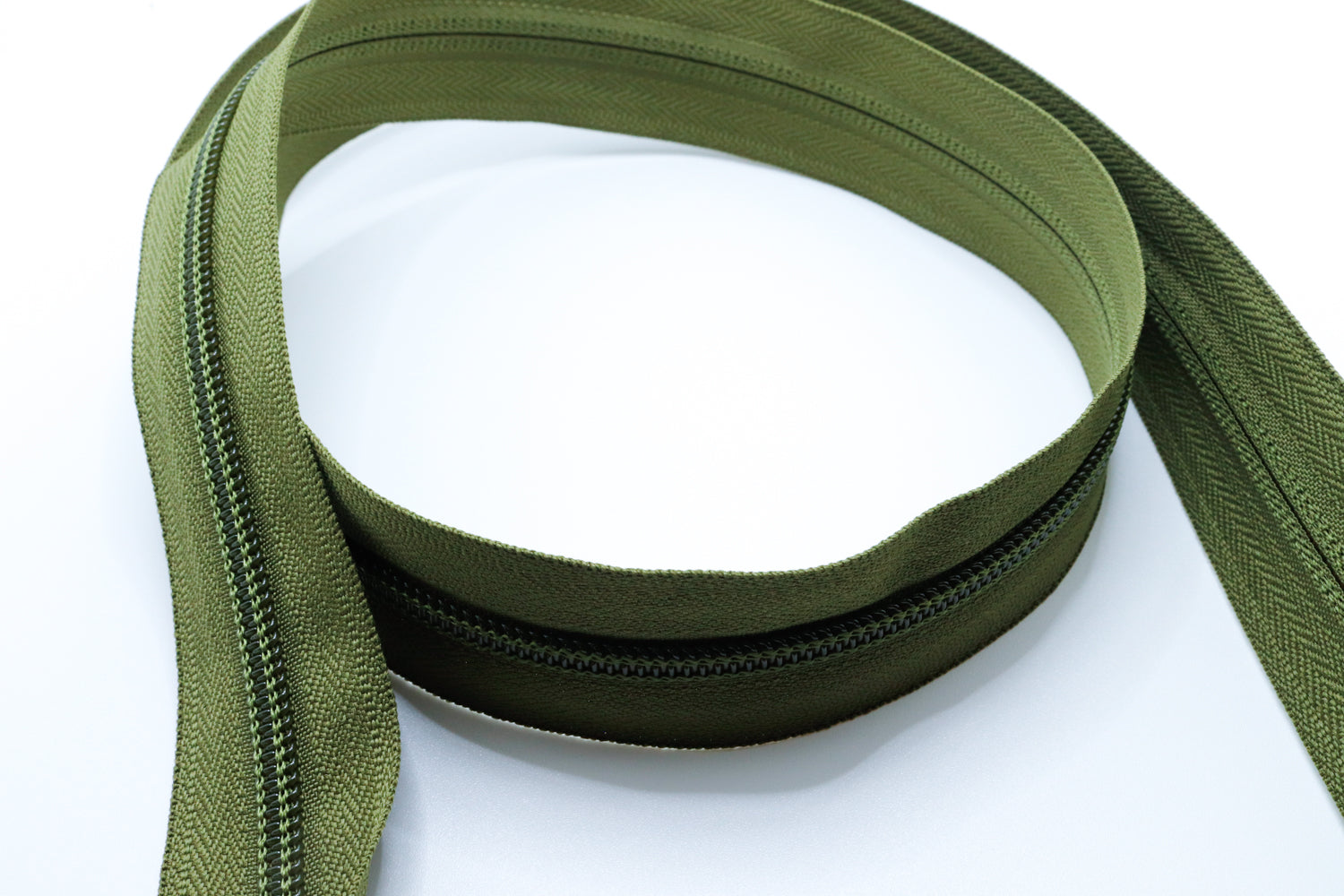 Army olive YKK #5 coil zipper chain on a white background