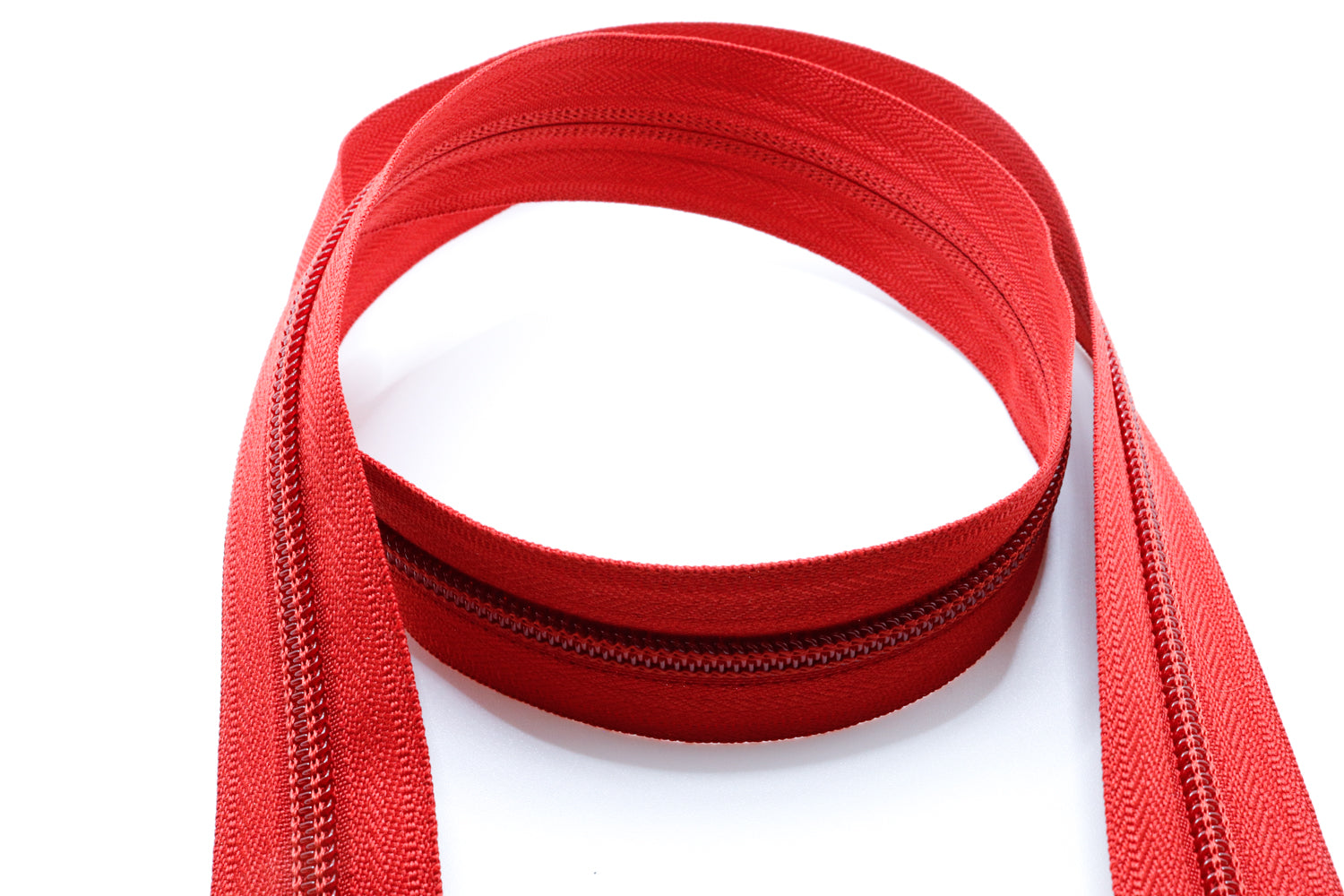 Brick red YKK #5 coil zipper chain on a white background