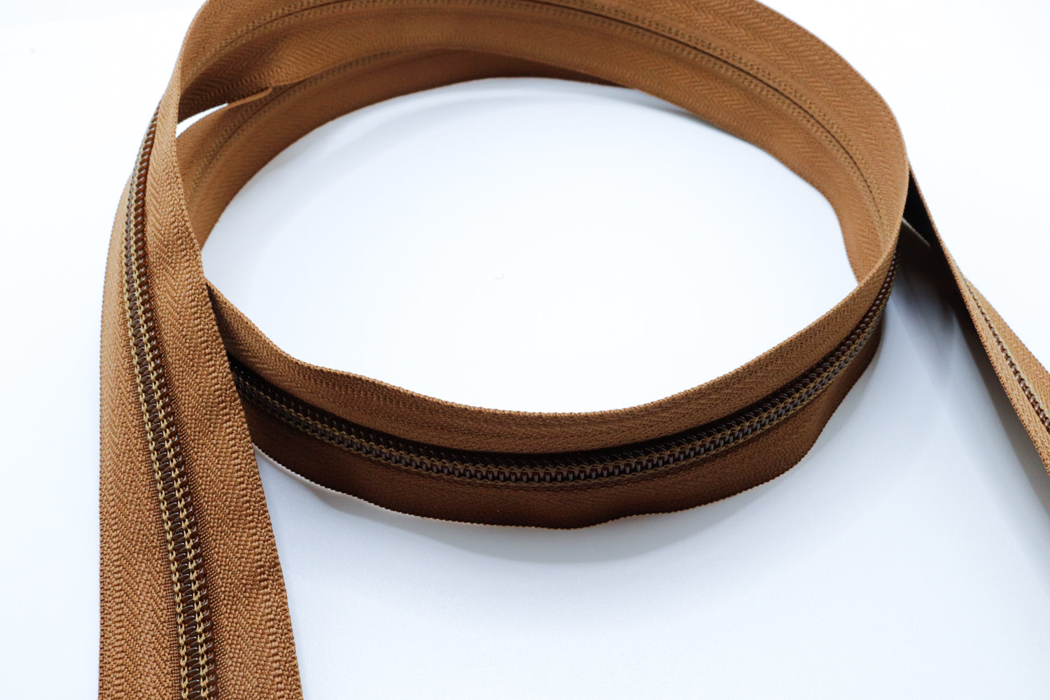 Coyote brown YKK #5 coil zipper chain on a white background