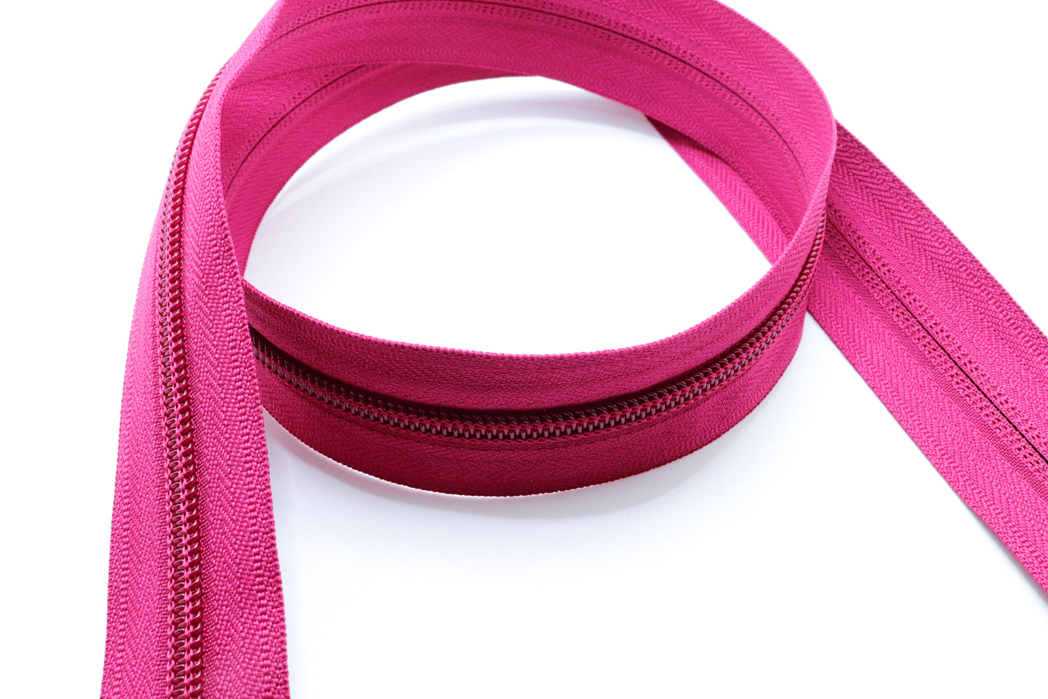 fuchsia YKK #5 coil zipper chain on a white background
