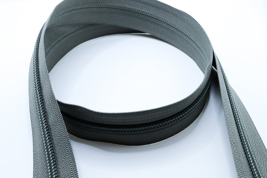 grey YKK #5 coil zipper chain on a white background
