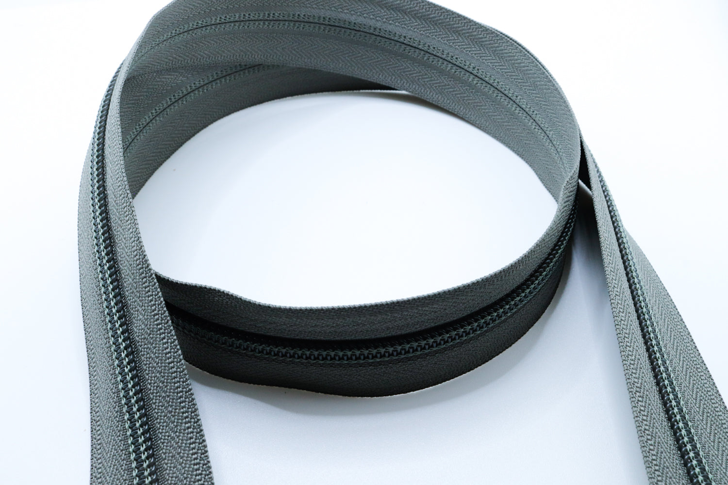 grey YKK #5 coil zipper chain on a white background