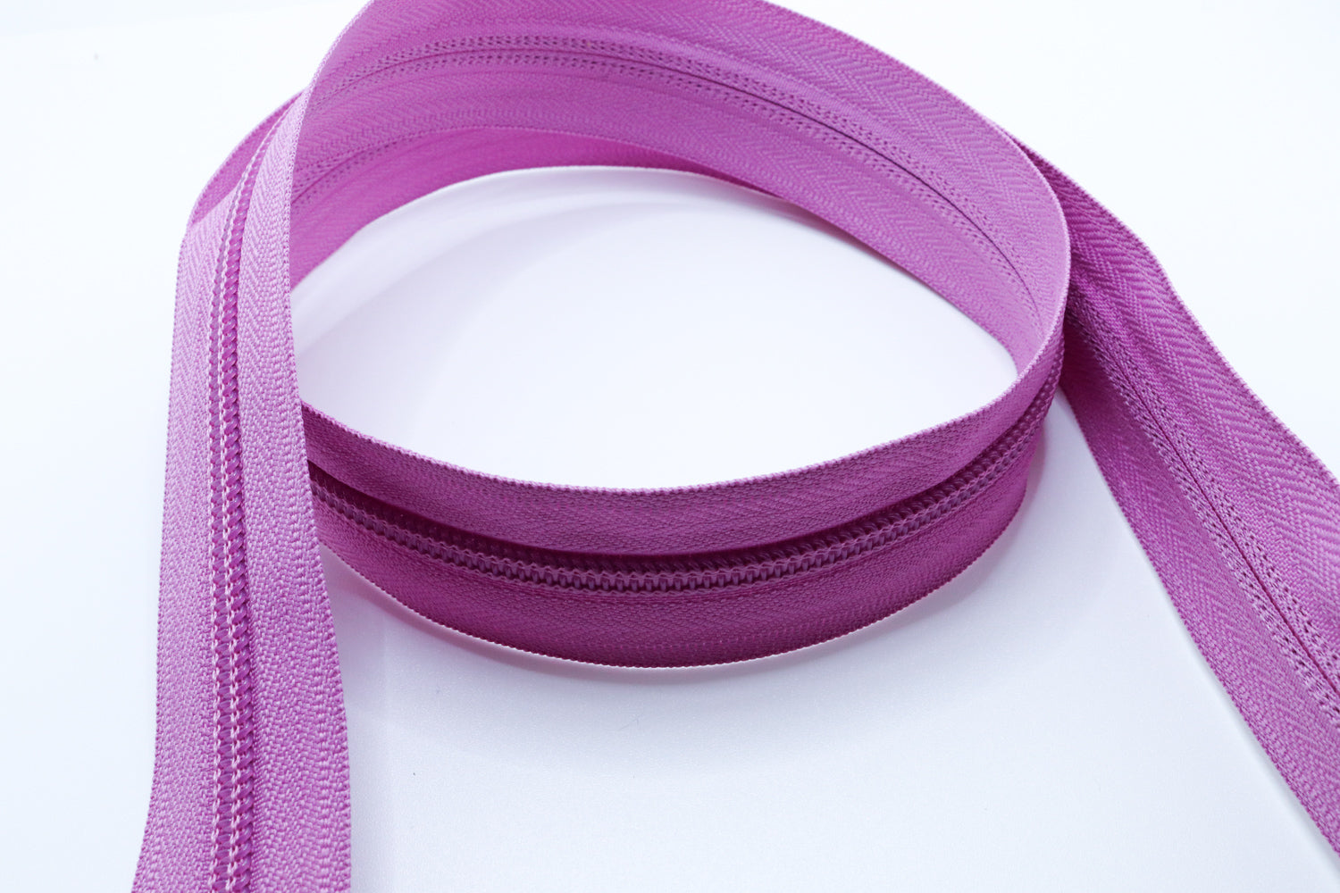 Lilac YKK #5 coil zipper chain on a white background