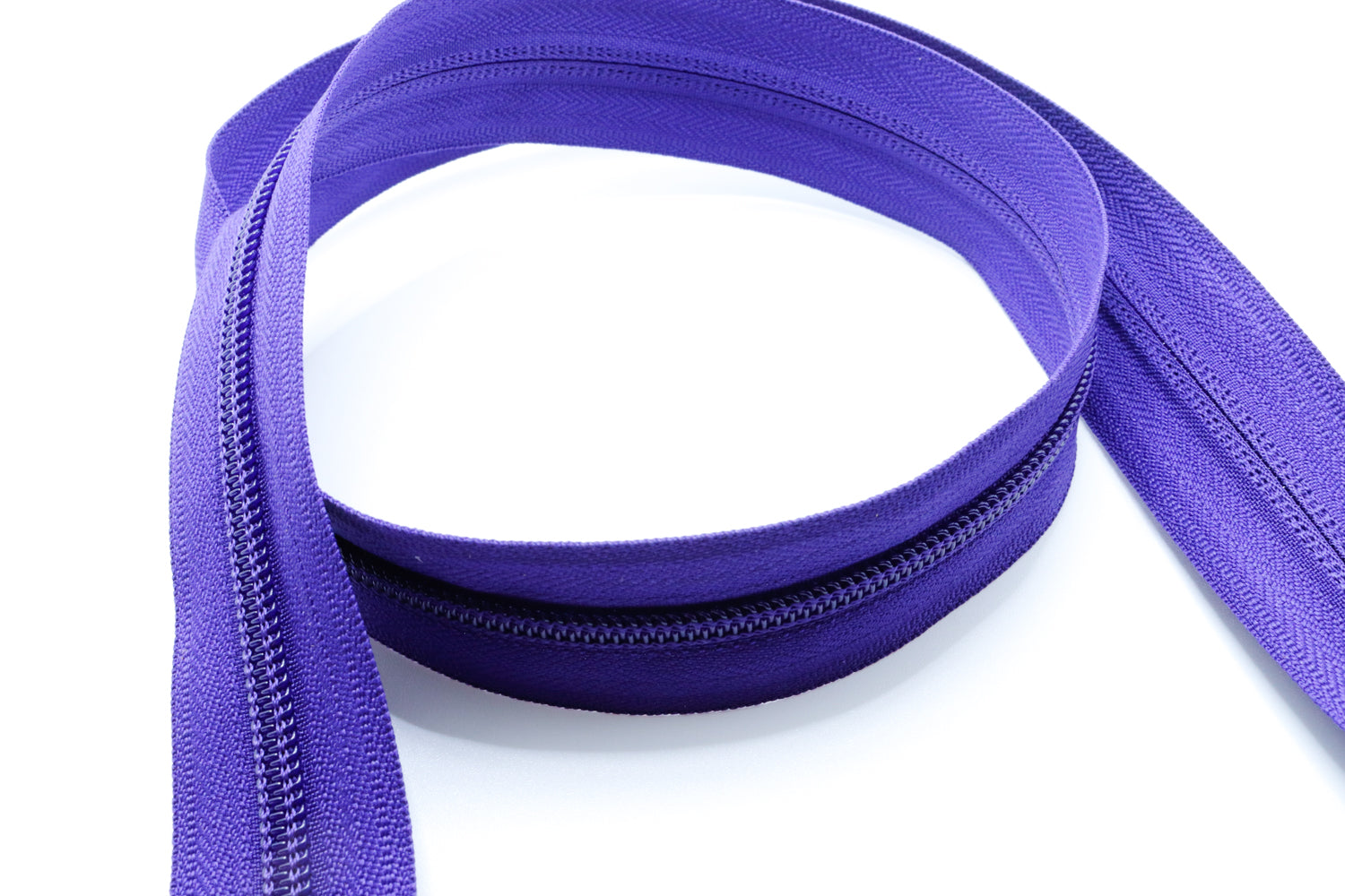 Purple YKK #5 coil zipper chain on a white background