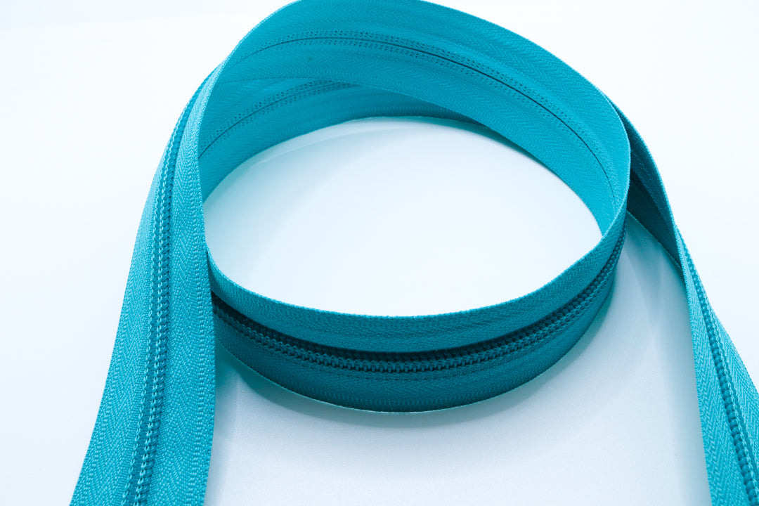 Teal YKK #5 coil zipper chain on a white background