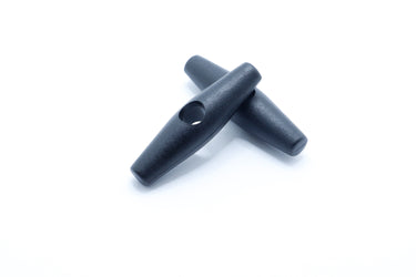 Black acetal toggle shown from the side with the cord hole visible
